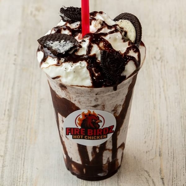 Oreo milkshake with whipped cream, chocolate drizzle, and a red straw, featuring the Fire Birdz logo.