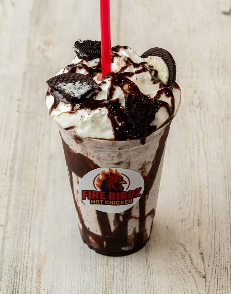 Oreo milkshake with whipped cream, chocolate drizzle, and a red straw, featuring the Fire Birdz logo.